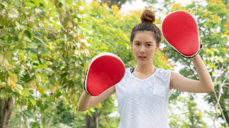 fit cute girl fitness and training warm up and boxing at outdoor park garden.の写真素材