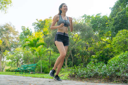 Fitness sport two slim fit and fat girls in fashion sportswear running in garden morning, outdoor sports.の写真素材