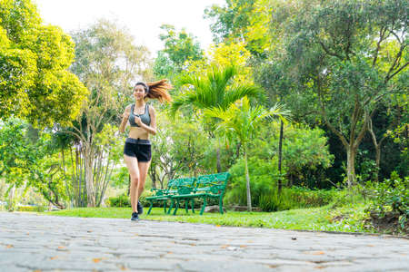 Fitness sport two slim fit and fat girls in fashion sportswear running in garden morning, outdoor sports.の写真素材