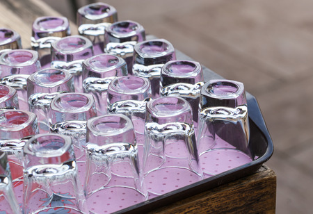 Clear glasses on wood trayの写真素材