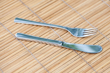 knife and fork on bamboo tray.