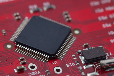 Black IC on red PCB.