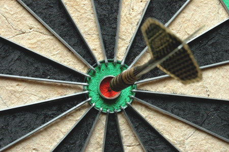 Darts board with single arrow in bullseye