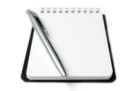 Clean sheet of notebook with a silvery fountain-pen from above. Isolated on white.