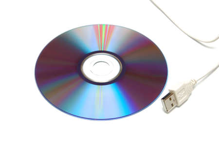 Blank CD-DVD disk and white USB cable. Isolated on white background. Close-Up shot.の写真素材
