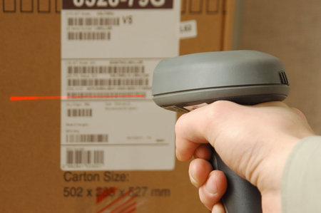 A man gets on the hip skaner in operations directed on printed barcode