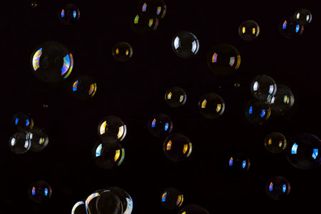 Multi colored soap bubbles on a black background