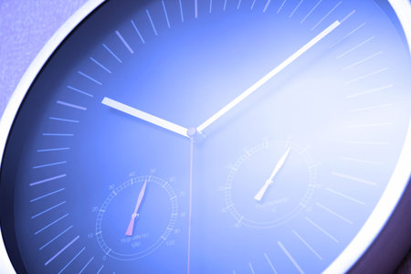 Blue tint multifunctional clock tilt view. Hygrometer and thermometer. Close-up.