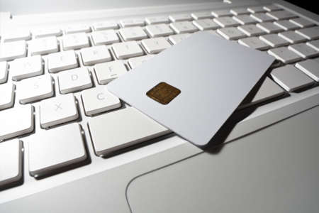 Smart card close-up on white laptop. Shallow DOF.の写真素材