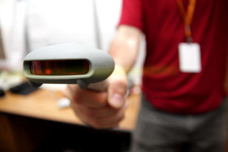 Man with bar code reader in action. Selective focus (shallow DOF).の写真素材