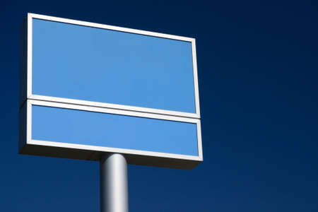 Blank blue billboard on a blue sky backgroundの写真素材