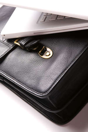 Laptop and brief-case on a white background. Nobody, business concept image.の写真素材