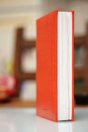 Orange book on a tableの写真素材