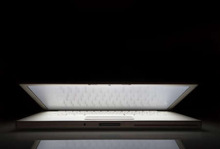 Silver laptop in the dark with copy space.の写真素材