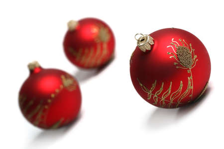 Three Red Christmas Balls Isolated On White Background. Tilt view, shallow DOF. More christmas ornaments You find in my portfolio.の写真素材