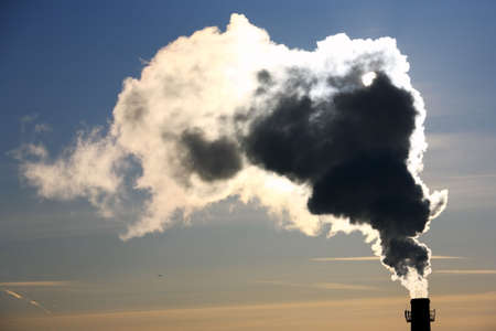 Pollution. Thick smoke from the chimney in winter morning. の写真素材