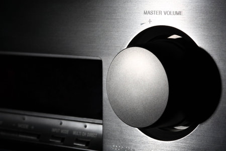 Home theater amplifier volume knob. Close-up shot in floodlit. Shallow DOF.