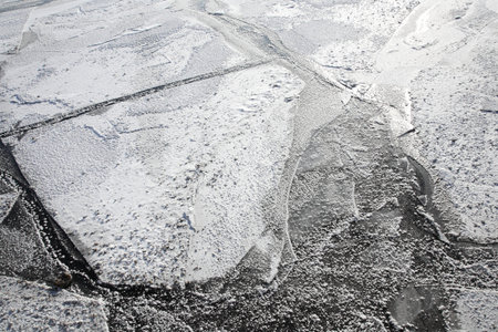 Winter background. River ice surface.