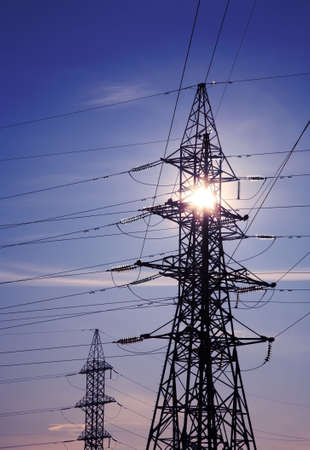 High voltage tower against the sun.の写真素材