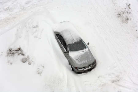 Snowfall. Vehicle in snowbank.の写真素材