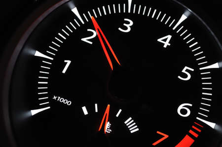 Part of cars dashboard. Illuminated tachometer closeup. Black background.の写真素材