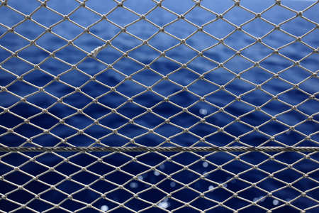 Marine background. Net with deep blue sea on a background.の写真素材