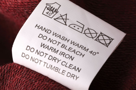 Label with laundry care symbols closu-up. Shallow DOF.