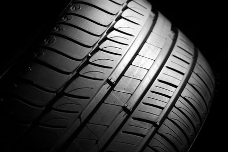 Modern high-performance sport summer tire on a black background  Low key scene の写真素材
