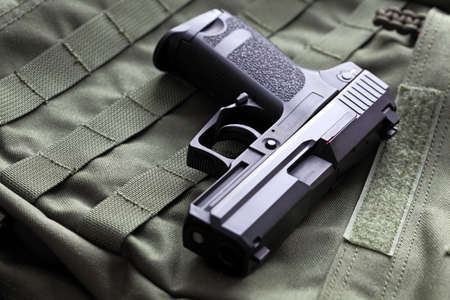 Weapon series. European 9mm semi-automatic pistol on a green background. Studio shot.の写真素材