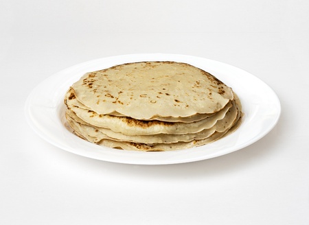 yellow pancakes on a white plate closeupの写真素材