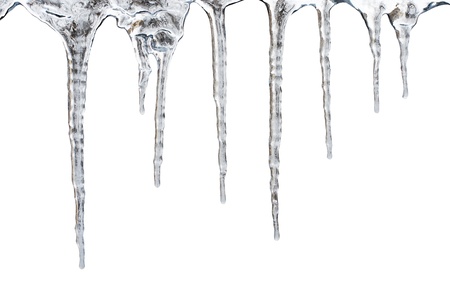 icicles which are hanging down from a roof. Isolated on white with clipping pathの写真素材