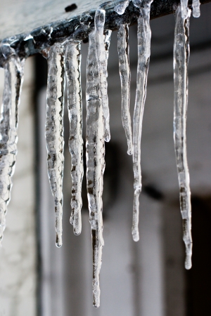 icicles which are hanging down from a roofの写真素材