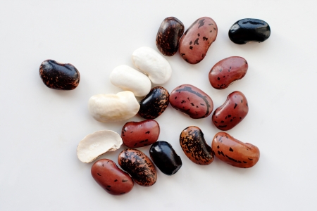 White, black and brown beans on white surfaceの写真素材
