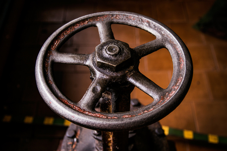 old handwheel of valve in a dark roomの写真素材