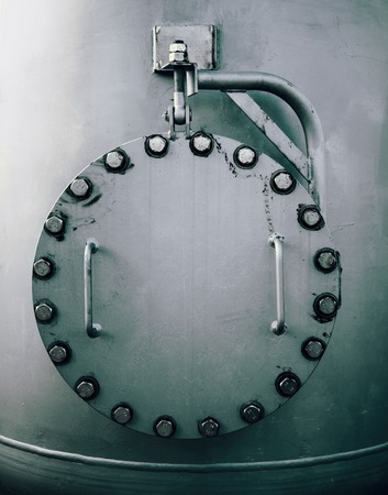 large steel manhole of a storage tankの写真素材