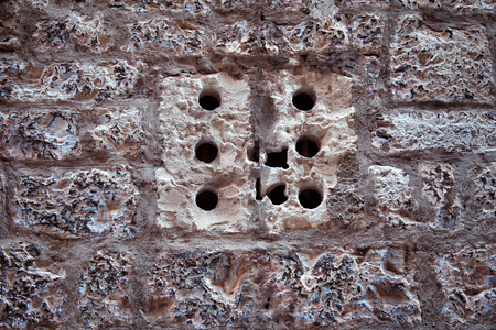 Stone Wall and window with holes in old town Sibenik, Croatiaの写真素材