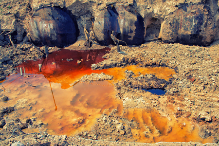 oil spills on the sand in an old tank farm.の写真素材