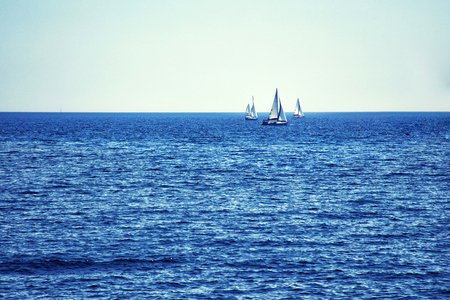 Luxury yachts at Regatta. Sailing in the wind through the waves at the Sea.の写真素材