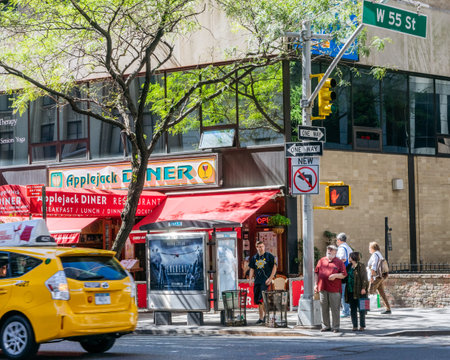 New York, USA - September 20, 2015: People wait for the green traffic light on the street of New...