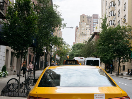 New York, USA - September 22, 2015:  Yellow taxi and people on the street of New York.