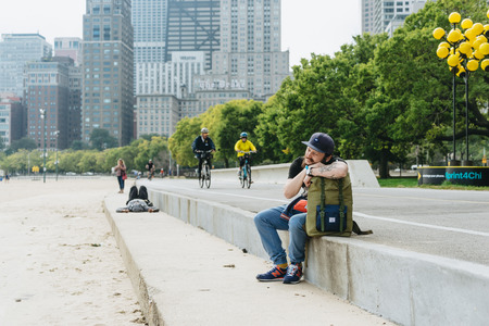 Chicago, USA - September 25, 2015: Tourist and bicycle on a lane.のeditorial素材