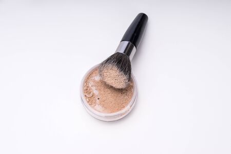 Make-up powder and brush isolated on whiteの写真素材