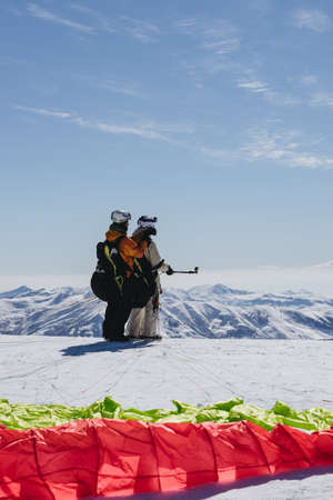 Gudauri, Georgia - February 16, 2016: Paragliding with beautiful cloudscape backgroundのeditorial素材