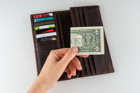 Brown leather wallet with money, credit and discount cardsのeditorial素材