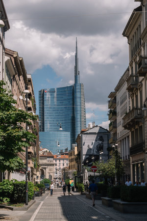 Milan, Italy - August 11, 2016: People are walking on the street against the Porta Nuova Garibaldi Towers in Milan, Italy.のeditorial素材