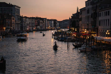 Venice, Italy - August 13, 2016: Gondoliers at dusk on the Grand Canal of Venice, Italy.のeditorial素材