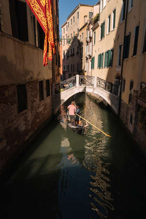Venice, Italy - August 14, 2016: Gondolier and tourists on the Canal of Venice, Italy.のeditorial素材