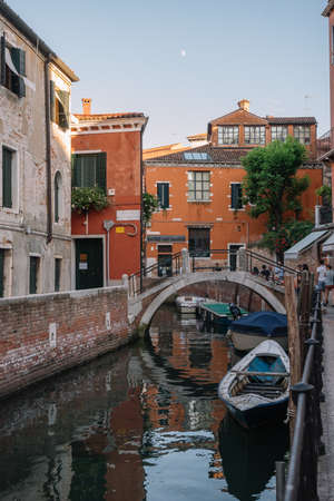 Venice, Italy - August 13, 2016: Tourists are walking by the canal of Venice, Italy.のeditorial素材