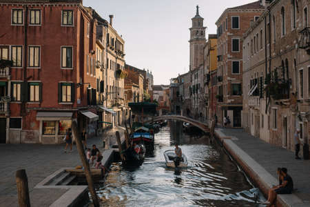 Venice, Italy - August 13, 2016: Tourists are resting by the canal of Venice, Italy.のeditorial素材