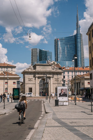 Milan, Italy - August 11, 2016: People are walking on the street against the Porta Nuova Garibaldi Towers in Milan, Italy.のeditorial素材